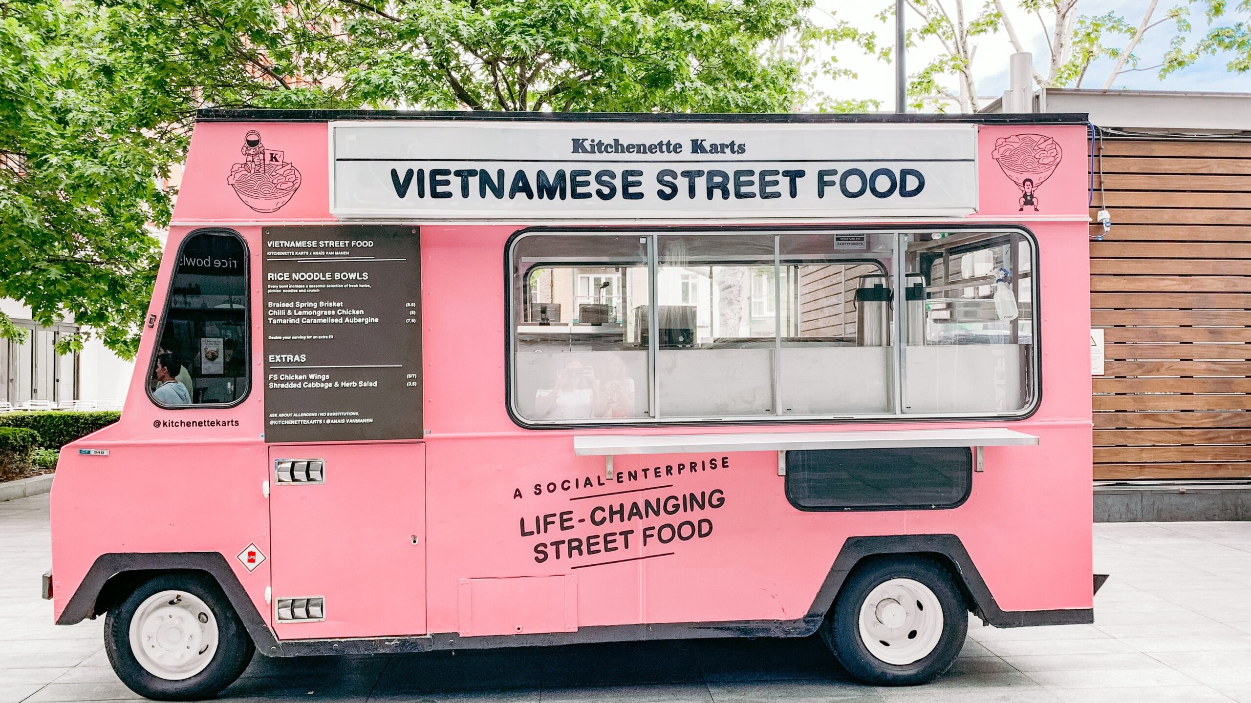 Colorful pink Vietnamese street food truck, representing the Food Truck Board Game featured on Family Games Oasis